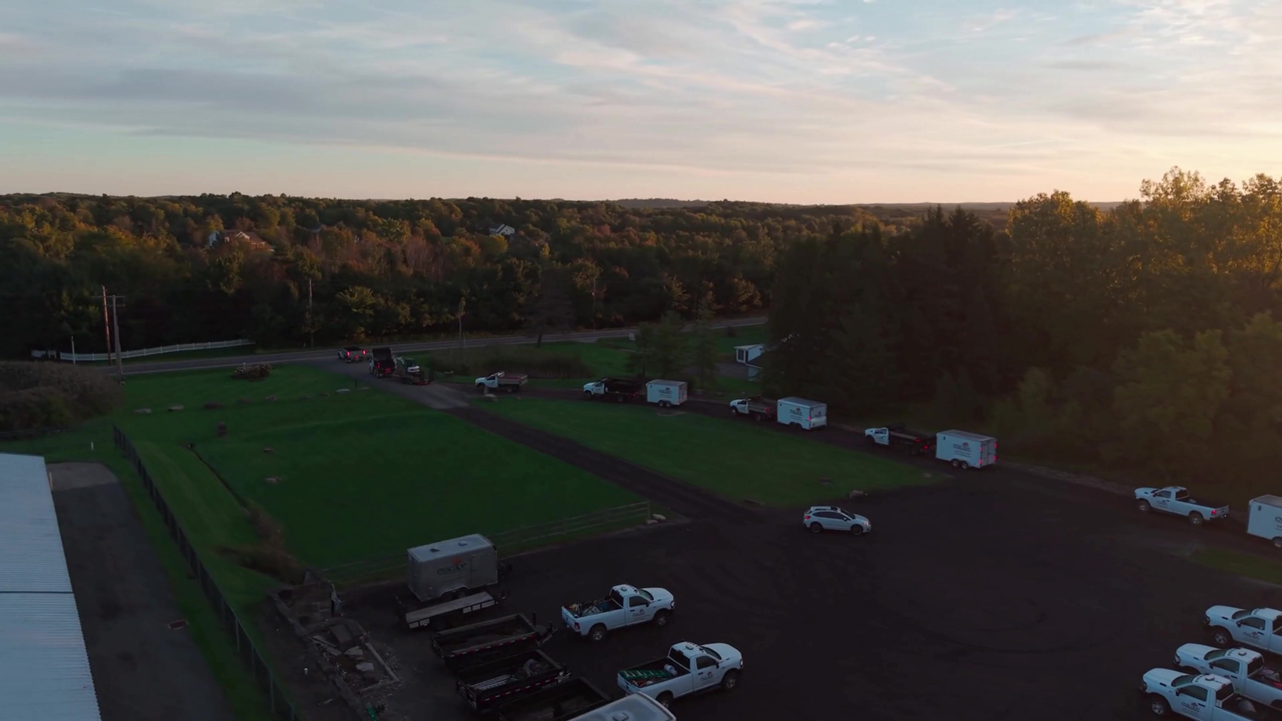 Aerial view of Exscape Group trucks and trailers lined up at dawn