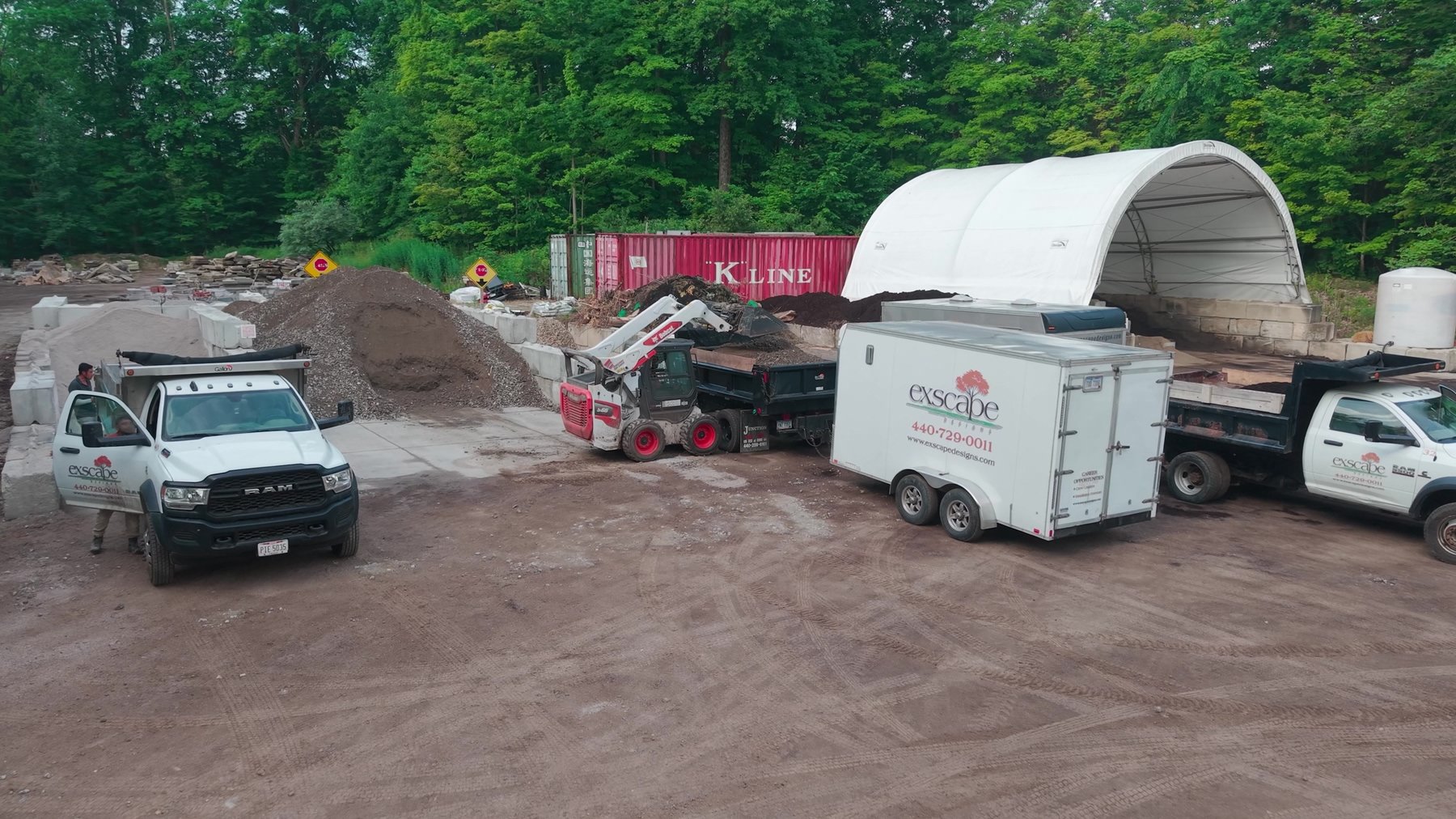 Aerial view of the Exscape Group materials yard with trucks and trailer