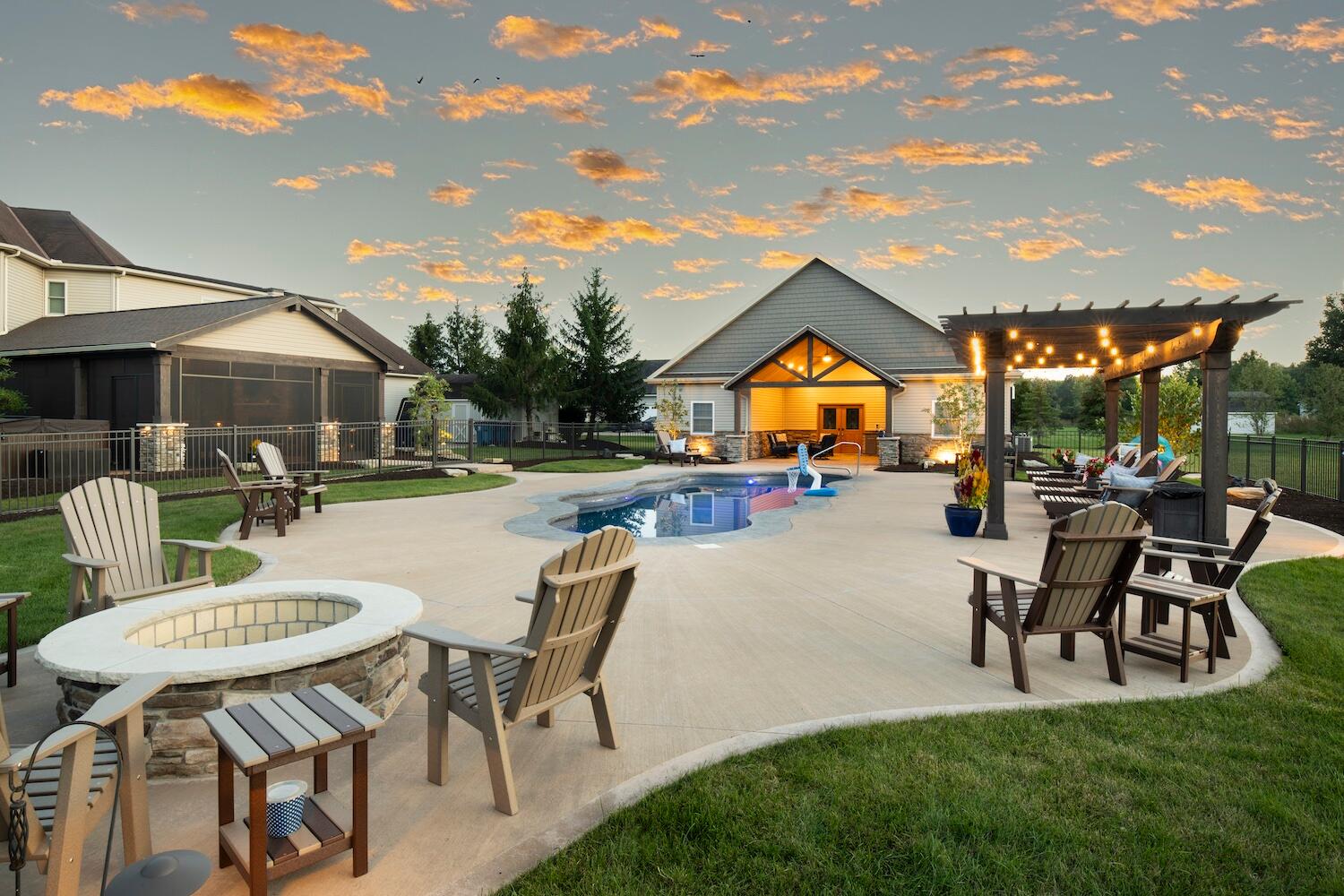 Backyard with fire pit, pool, and pergola outdoor living space in Novelty OH