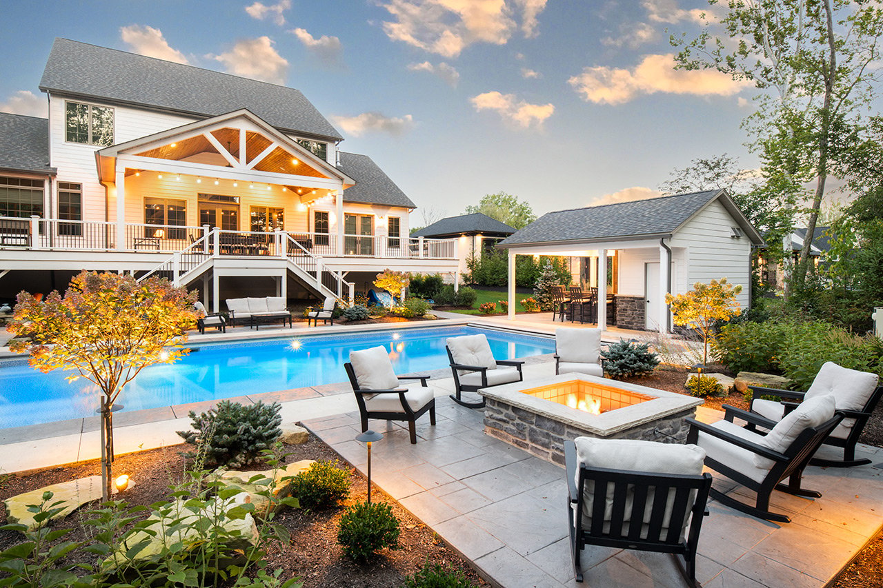 Large-format paver patio and pool at dusk in Sheffield Village, OH