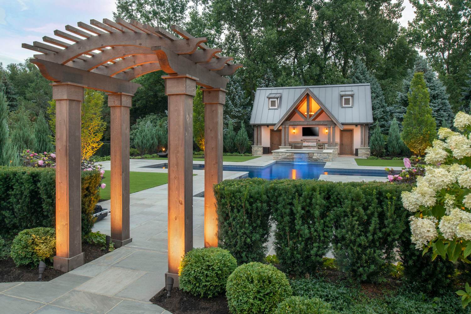 Elegant outdoor pool area with seating and fire pit at a residential property in Sheffield, Ohio