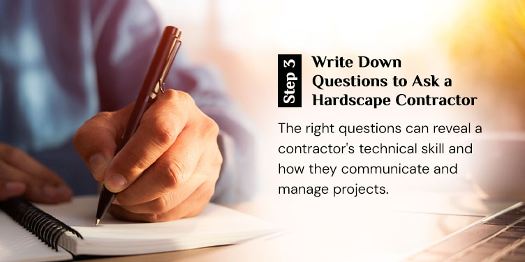 Homeowner writing down questions to ask a hardscape contractor in a notebook