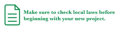 A green icon of a sheet of paper with green text reading "Make sure to check local laws before beginning with your new project."