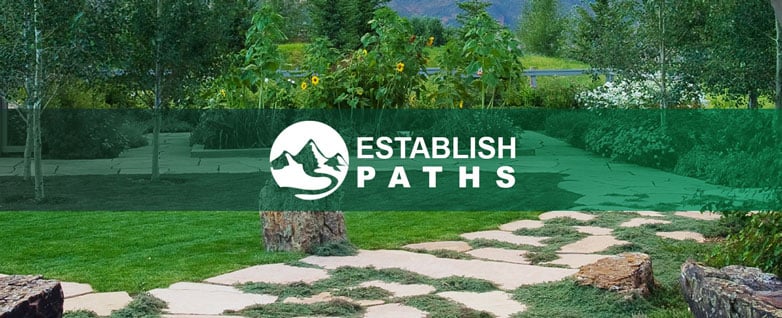 A grassy large stone pathway is seen trailing off into flowerbeds in the background, with a green banner overlayed with a white mountain trail icon over top with text right next to it reading "Establish paths"