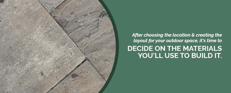 Textured stone floor tiles cropped into a circle with text to the right reading "After choosing the location and creating the layout for your outdoor space, it's time to decide on what materials you’ll use to build it."