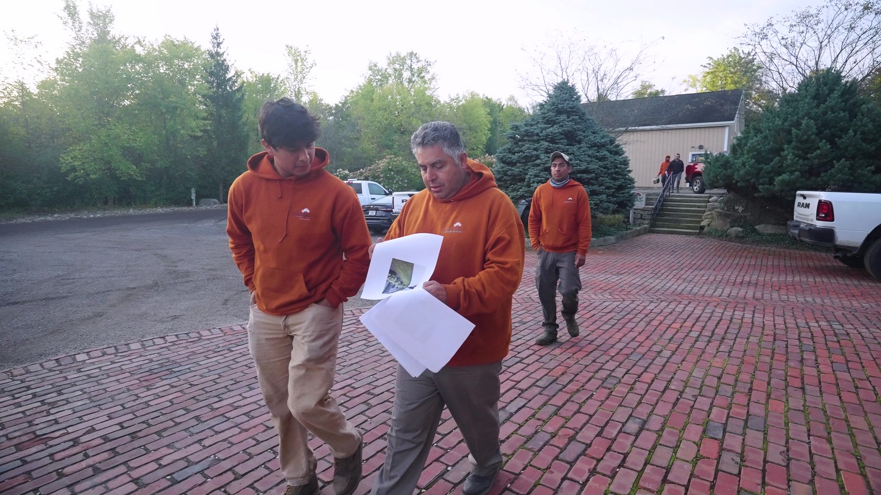 Exscape Group crew leader reviewing landscape plans with his team