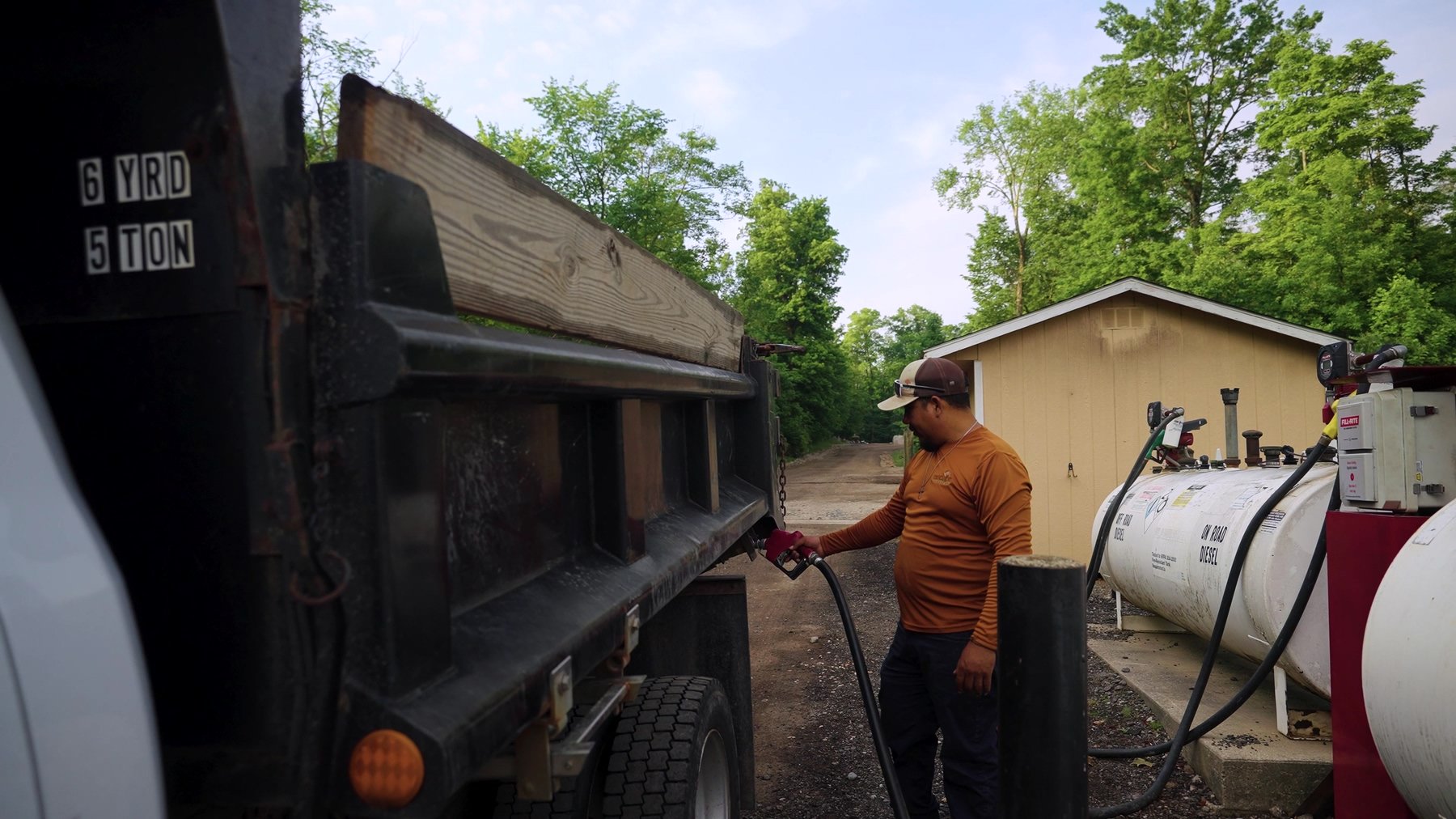 Exscape Group crew member fueling a dump truck Exscape Group crew member fueling a dump truck