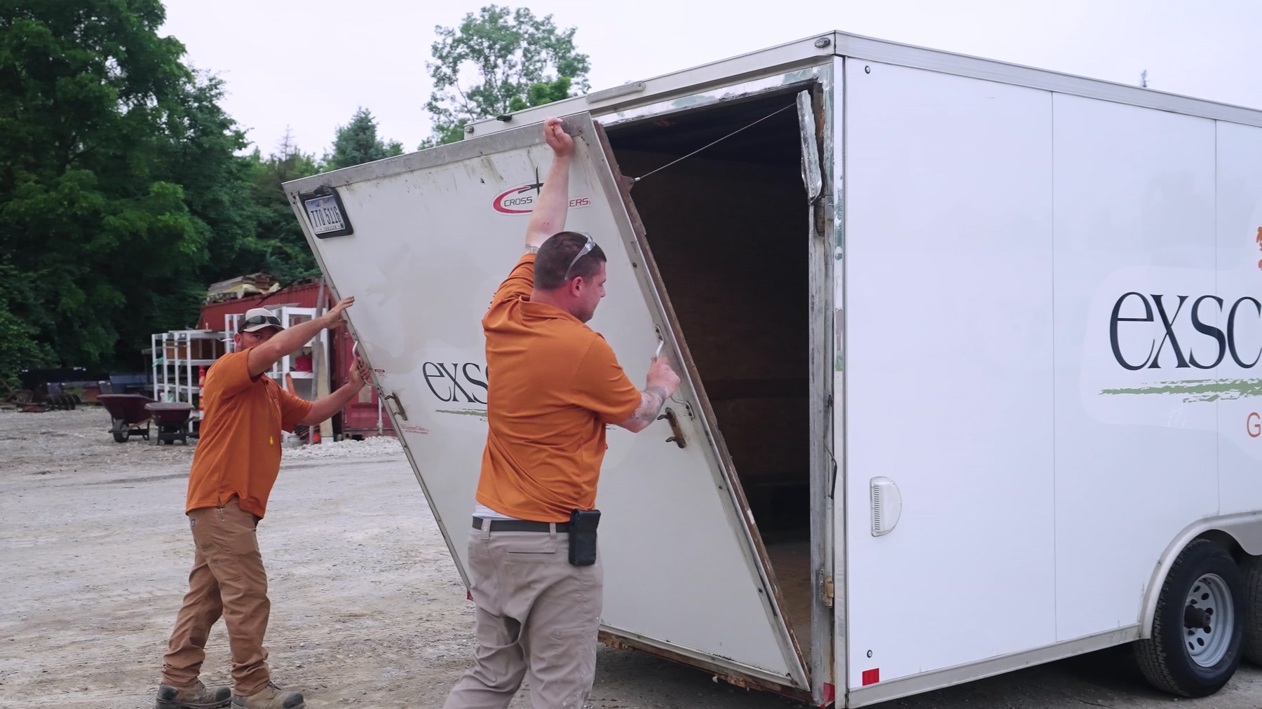 Exscape Group crew members opening a company enclosed trailer Exscape Group crew members opening a company enclosed trailer