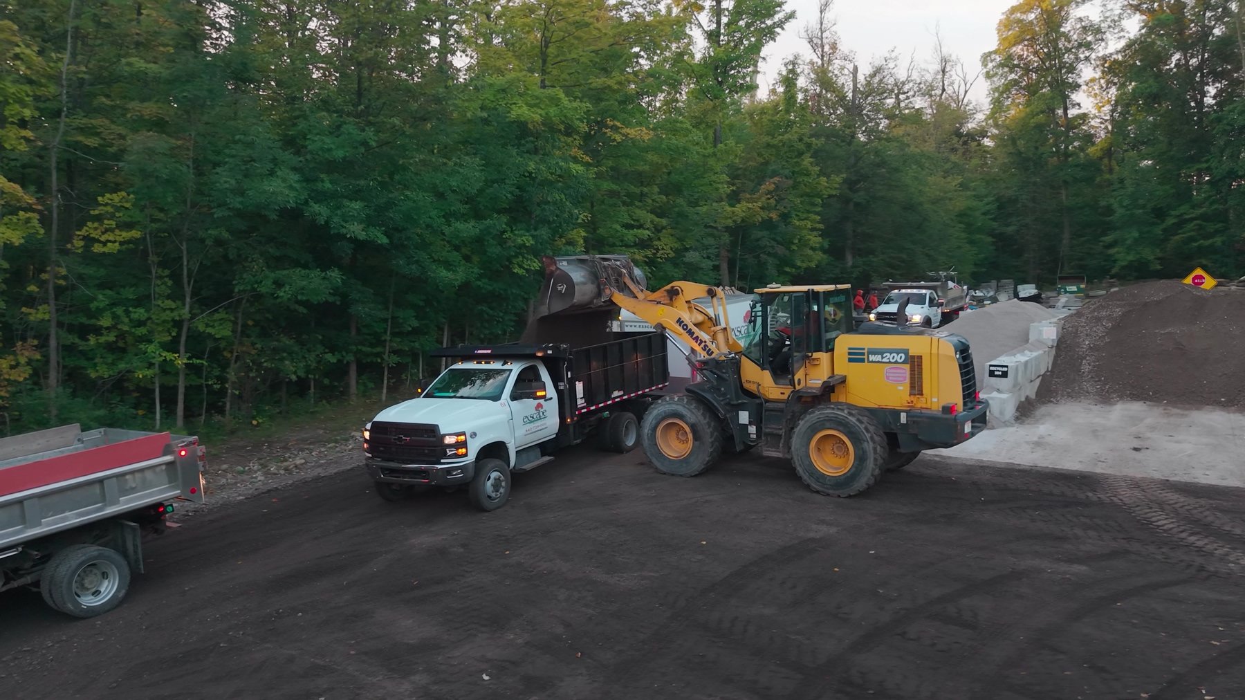Exscape Group loader filling a dump truck in the materials yard