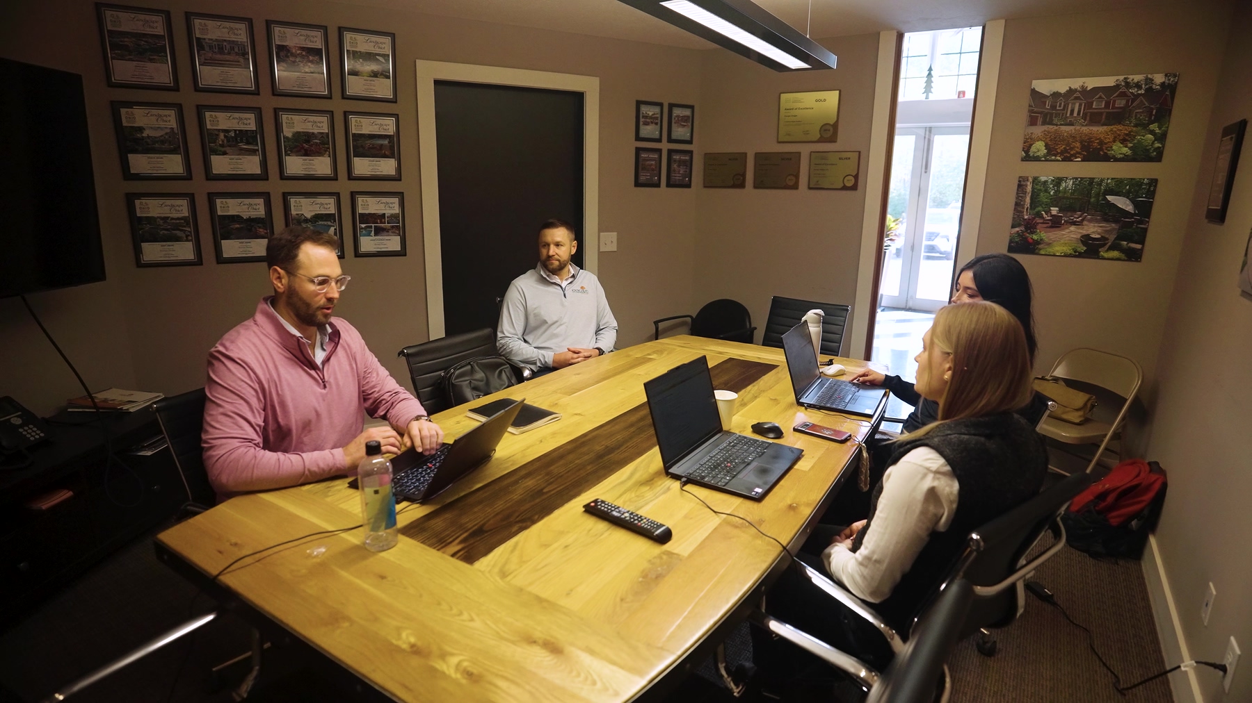 Exscape Group team meeting in the conference room