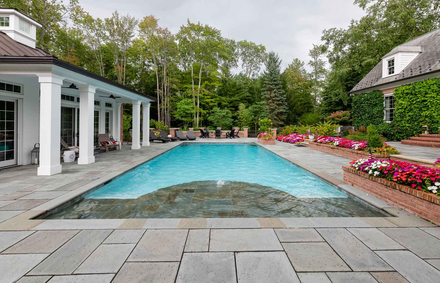 Custom outdoor pool design in South Russell, OH with slip-resistant entry steps