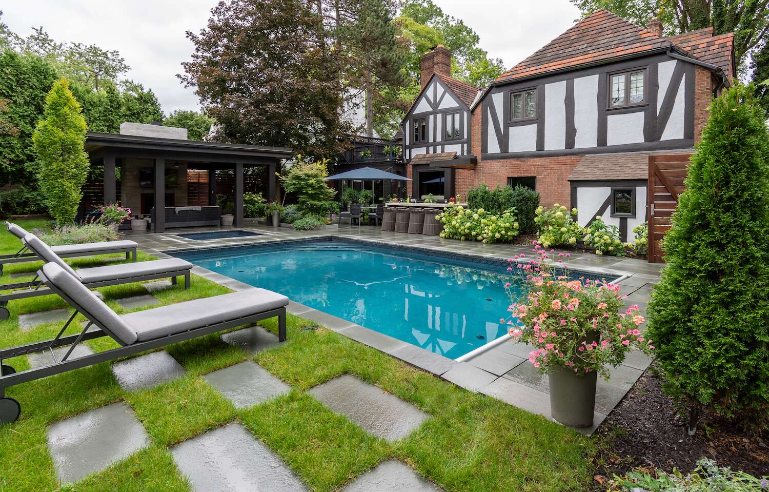 Backyard pool with stepping-stone lawn and covered outdoor living area in Bainbridge, OH