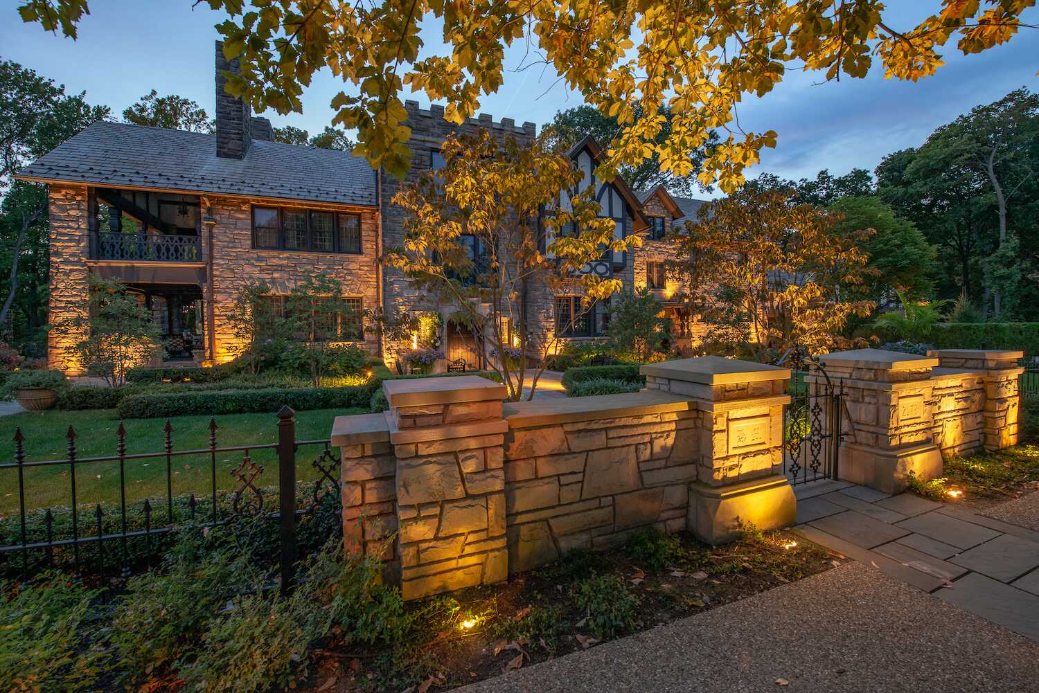 Landscape lighting on stone walls and plantings at an Ohio home at night