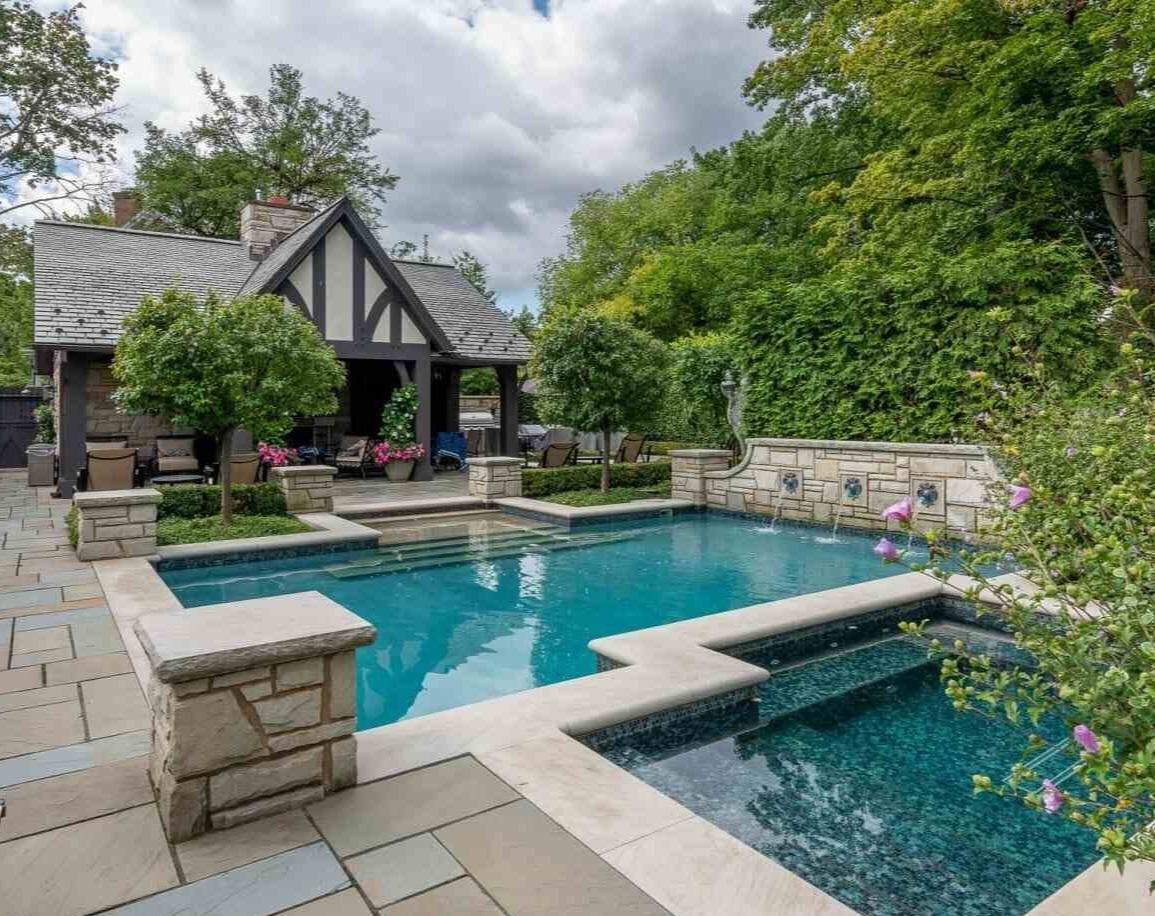 Stunning backyard pool and spa with elegant stonework at a private residence in Pepper Pike, OH