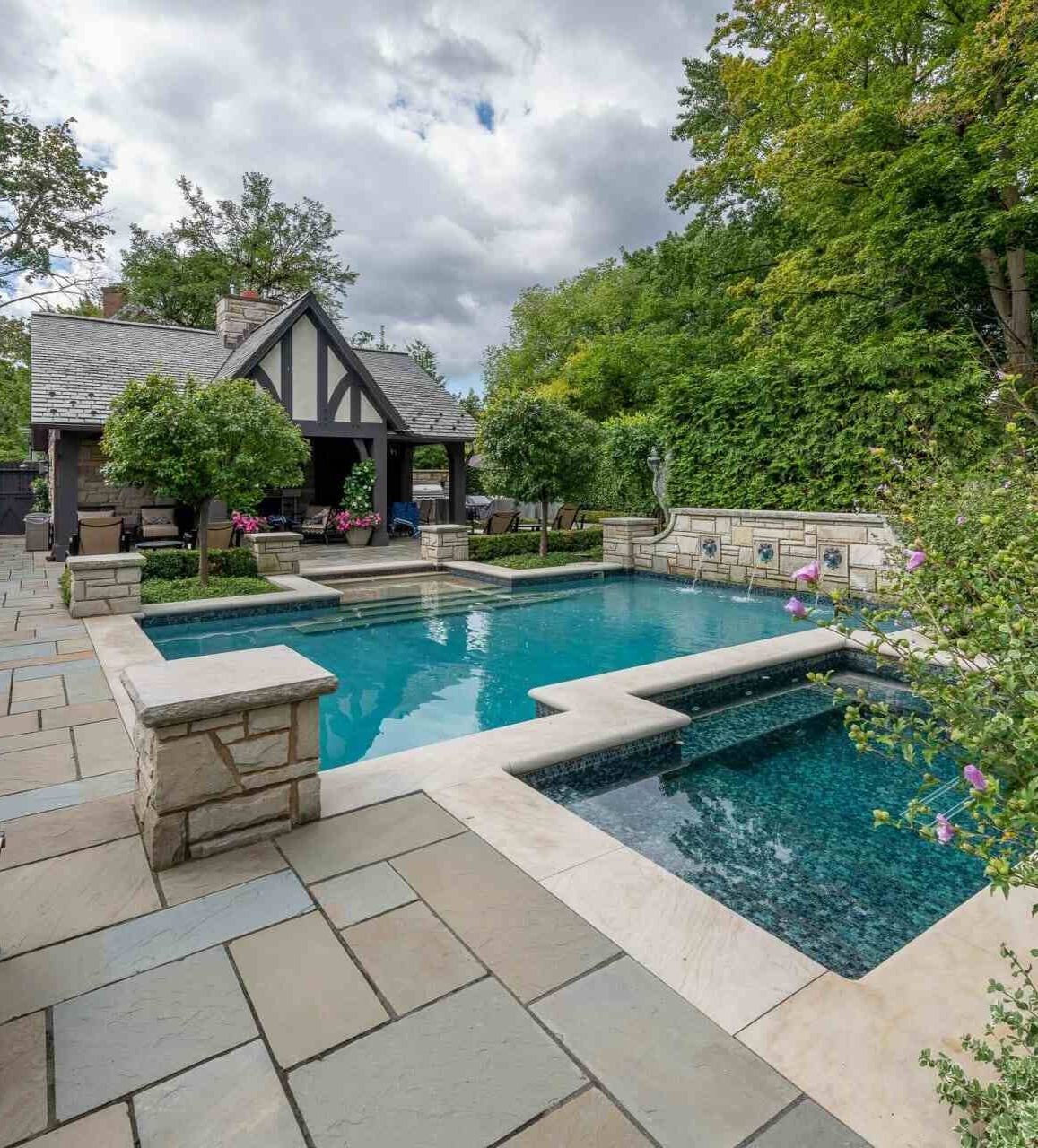 Stunning backyard pool and spa with elegant stonework at a private residence in Pepper Pike, OH