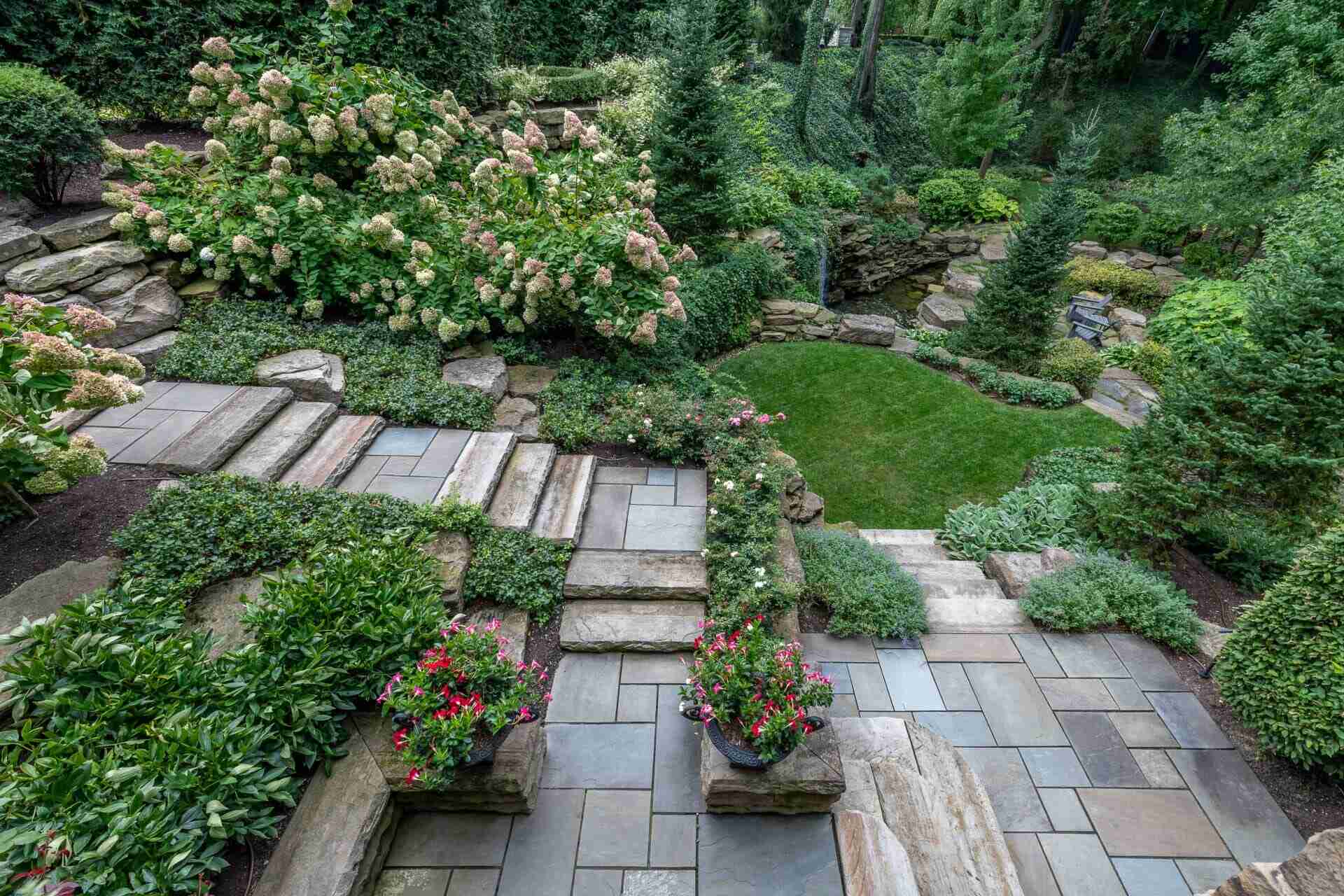 Timeless stone steps leading to a serene courtyard in a luxury landscape project in Chagrin Falls, OH