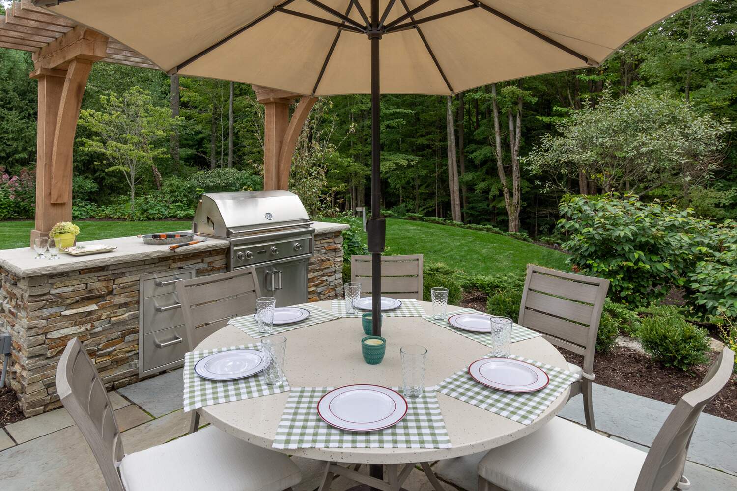 Fully equipped outdoor kitchen with a built-in fridge and grill in Beachwood, OH