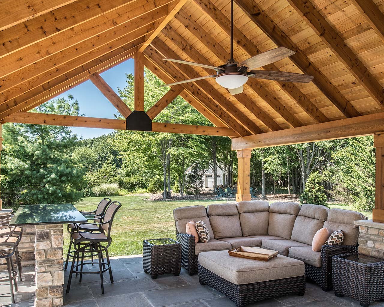 Wood pergola over a paver patio with outdoor seating