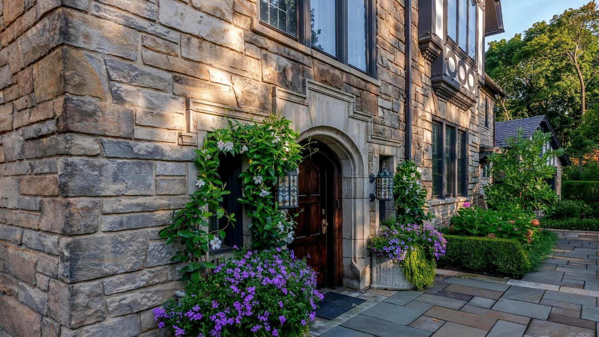 Stone house entry with climbing vines and a stone walkway