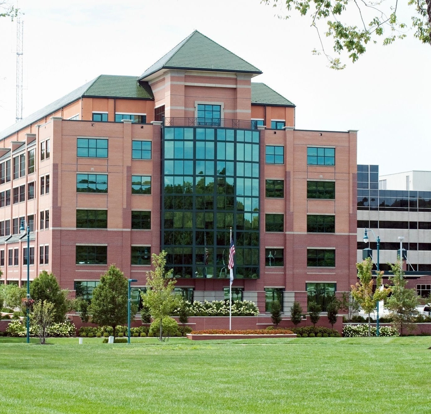 Office building with landscaped grounds and a manicured lawn