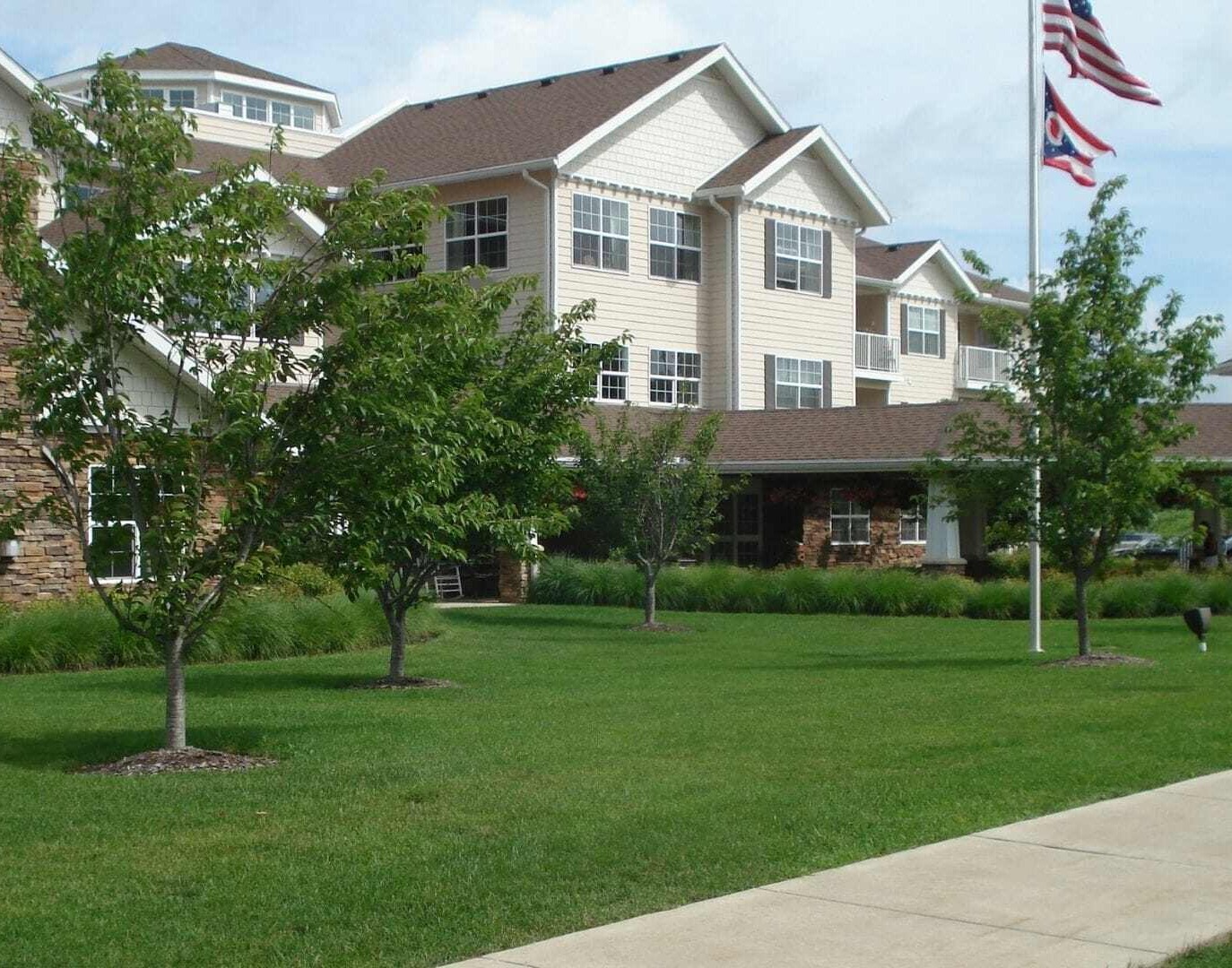 Maintained lawn and trees at a multi-story residential community