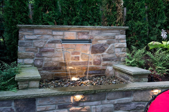 Custom low-maintenance landscape with water features