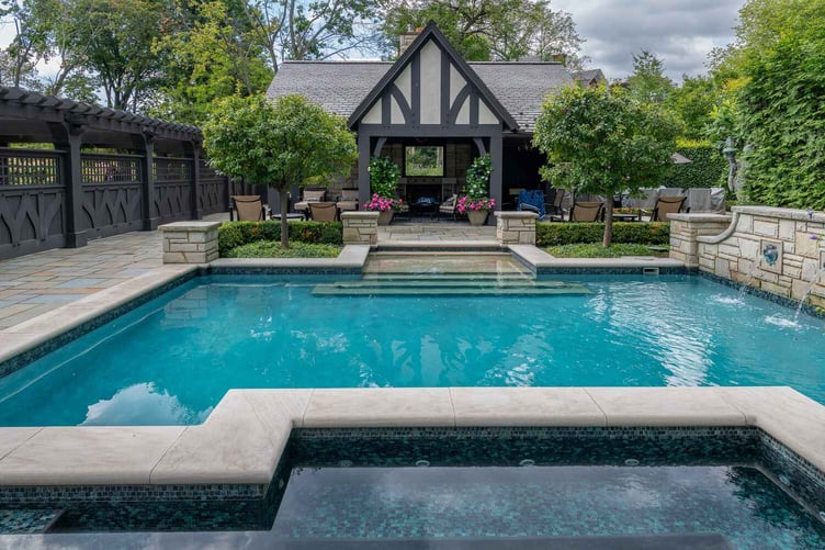 Modern backyard pool with swim-up seating in Beachwood, OH for entertaining