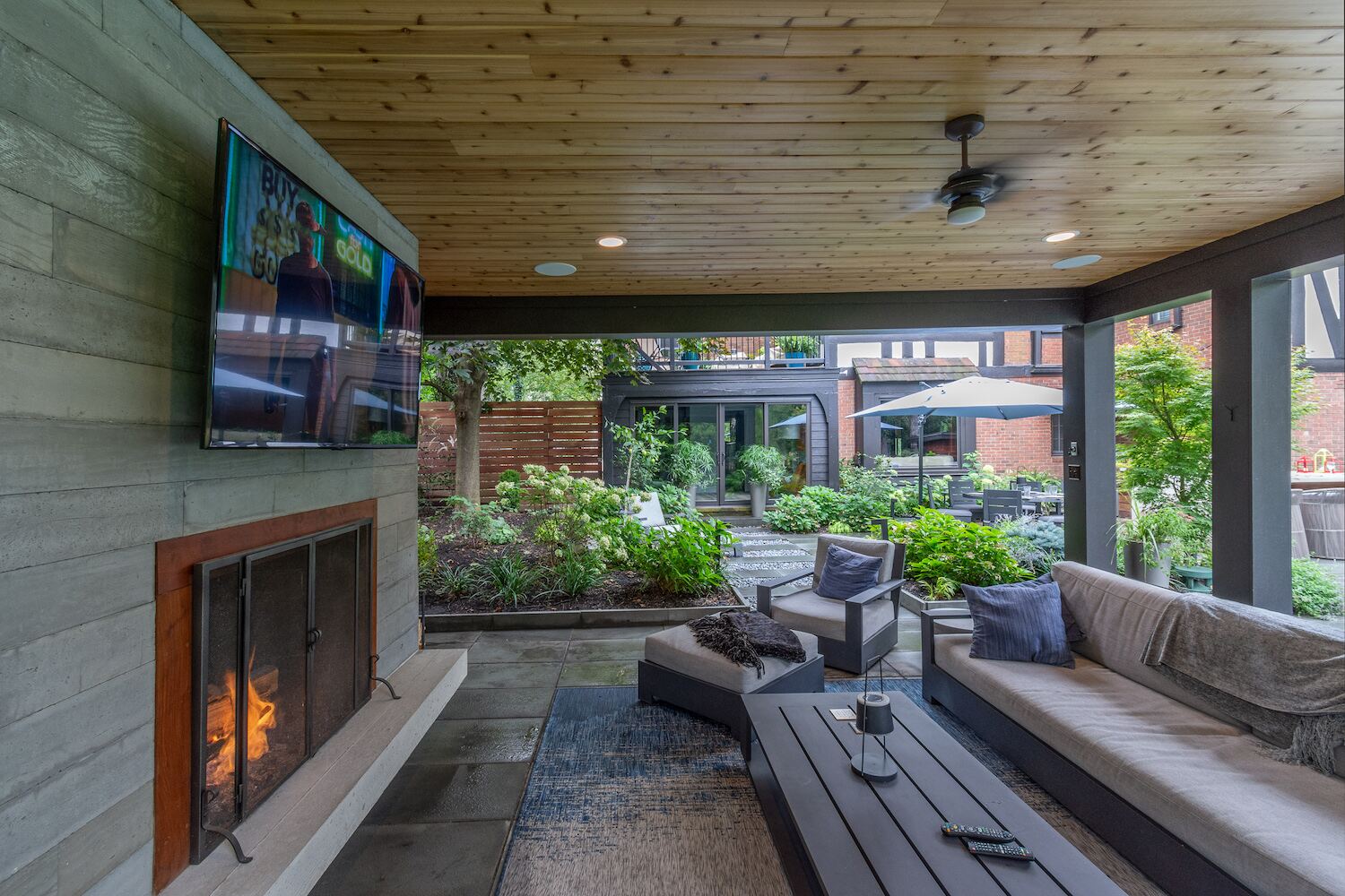 Modern outdoor pavilion featuring a built-in fireplace and TV in Bainbridge, OH