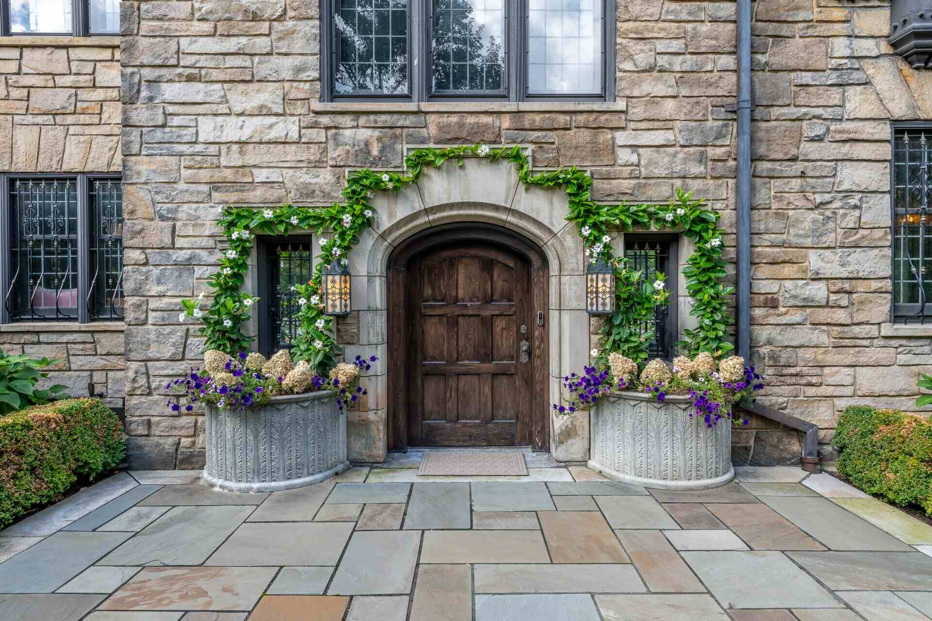 Ornate potted plantings and vibrant garden beds enhancing a historic estate in Gates Mills, OH