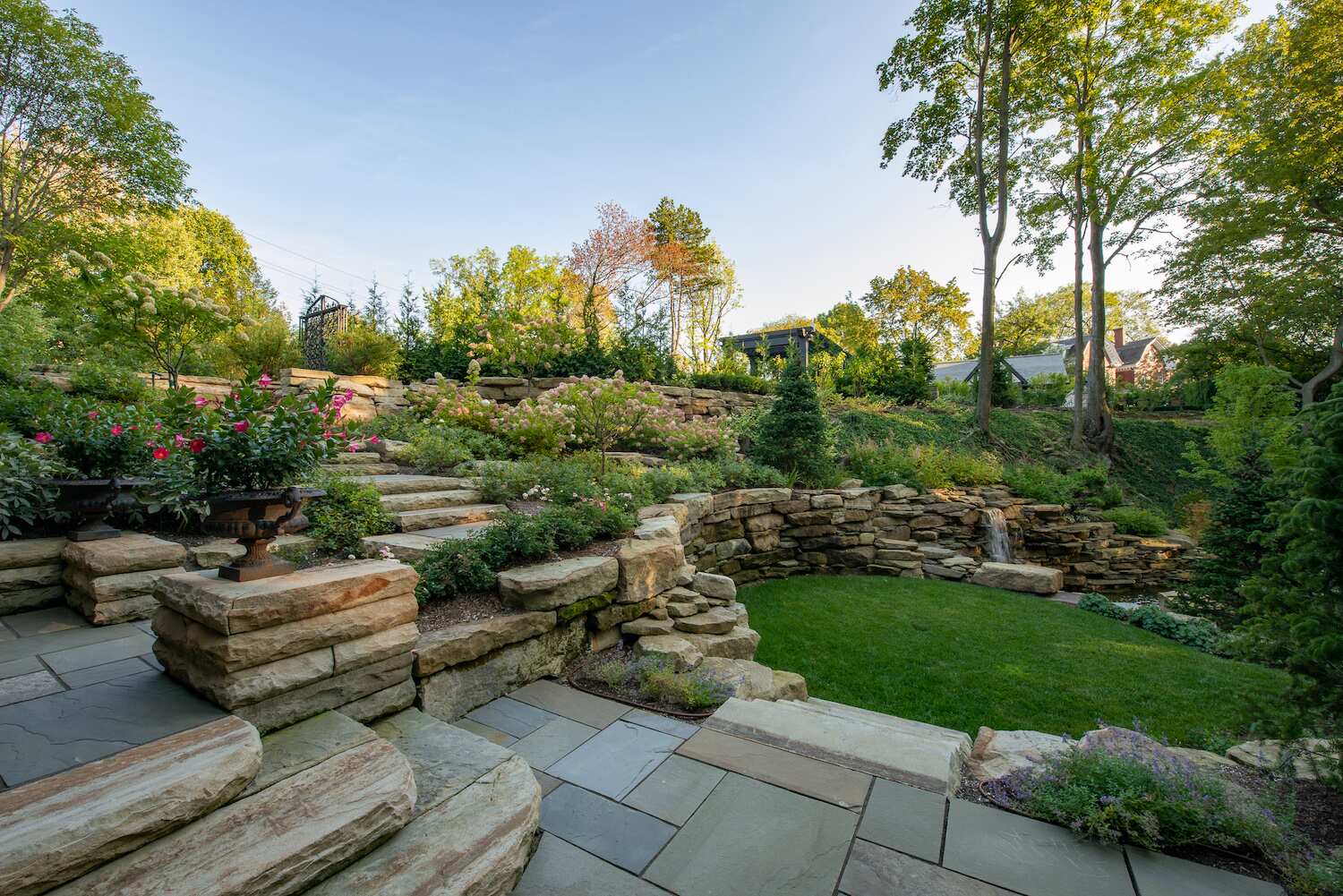 Stone retaining walls and steps with layered plantings