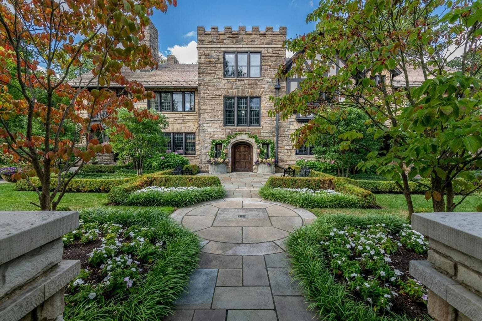 Stone walkway and garden beds leading to a historic stone home Stone walkway and garden beds leading to a historic stone home