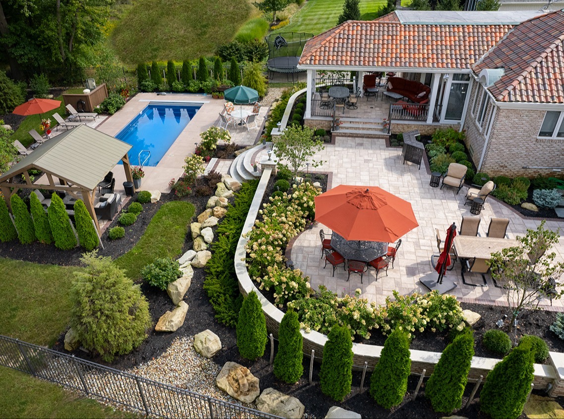 Aerial view of a backyard with pool, patio, and pergola Aerial view of a backyard with pool, patio, and pergola