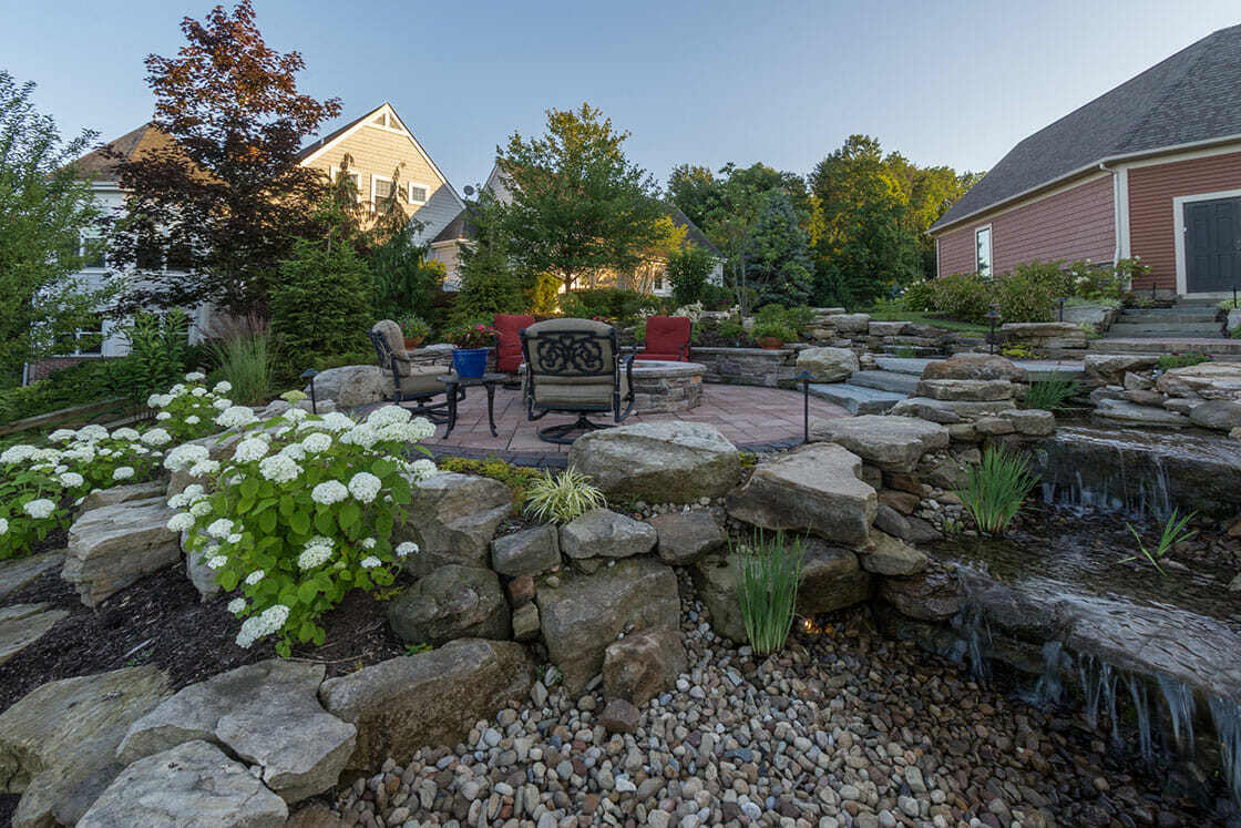 Spacious outdoor dining patio with elegant furniture overlooking the water in Auburn Township, OH