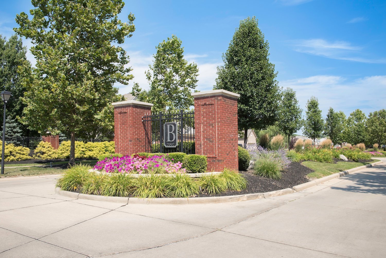 Brick entrance monument with landscaped beds at a commercial property