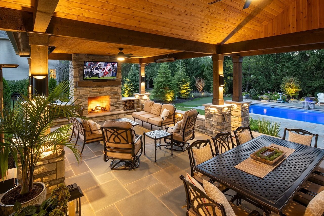 Covered pavilion with outdoor dining, lounge seating, and TV