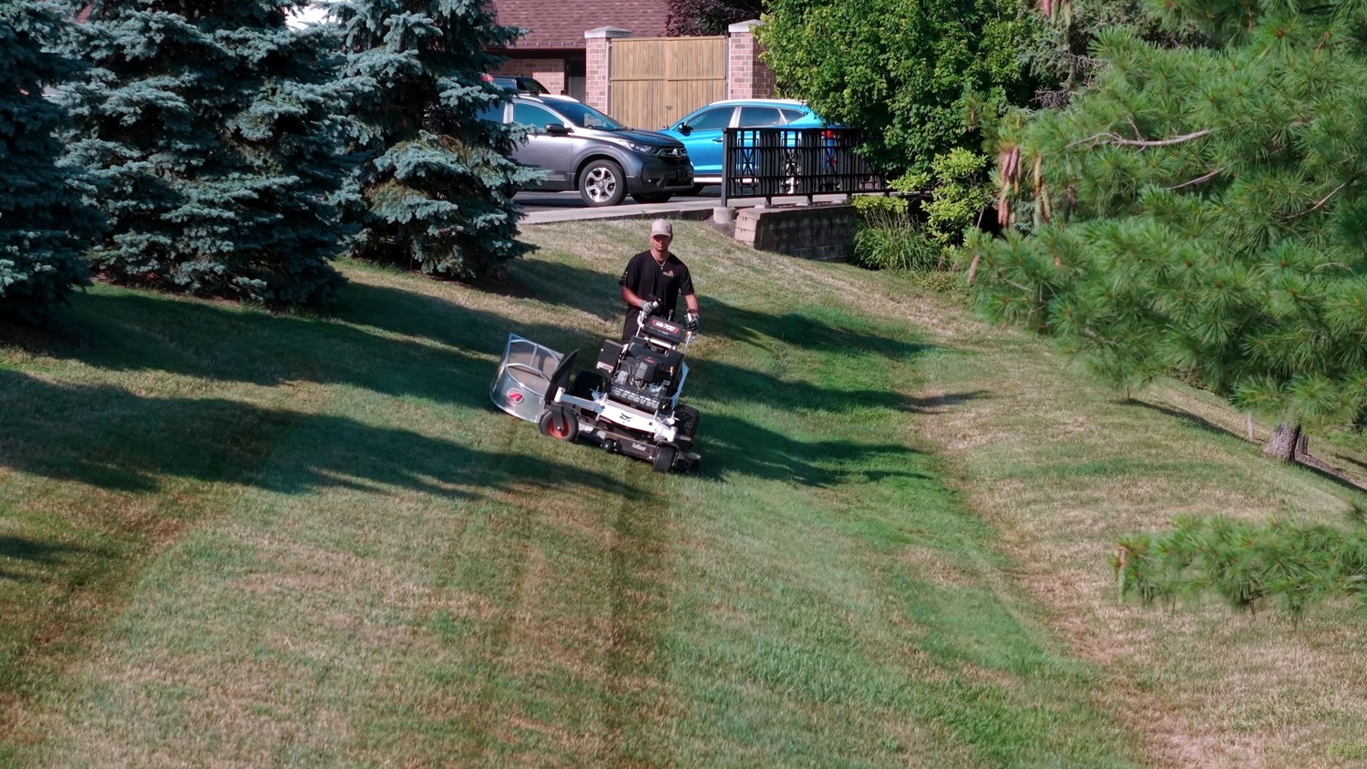 Crew member aerating a residential lawn