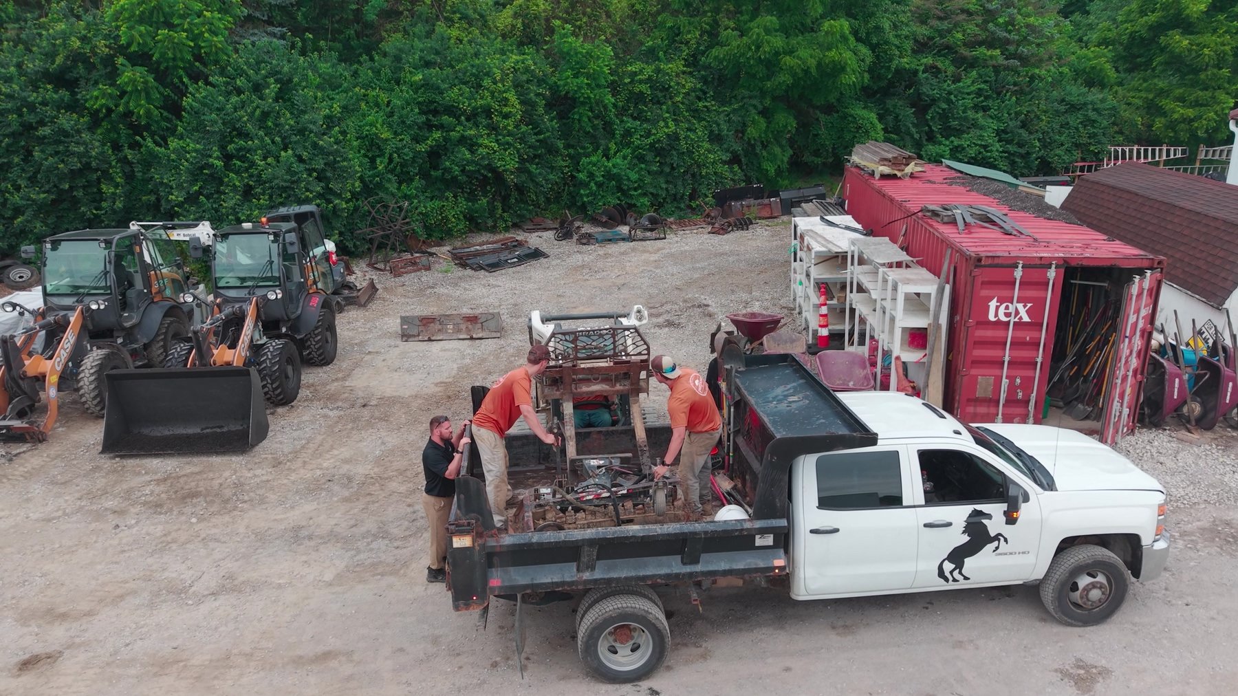 Aerial view of Exscape Group crew loading equipment onto a flatbed truck