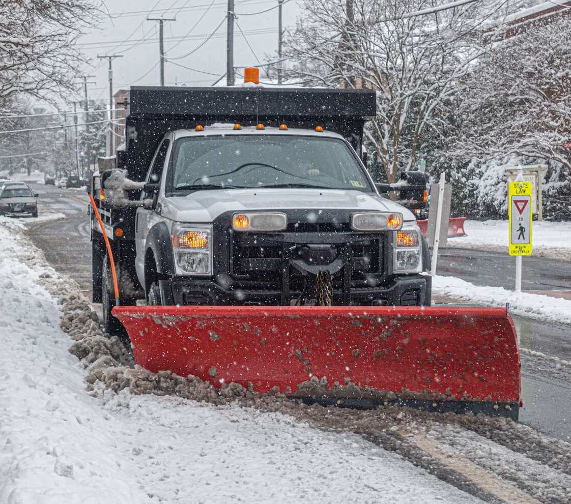 Plow truck clearing snow on a customized snow management plan in Auburn Township, OH