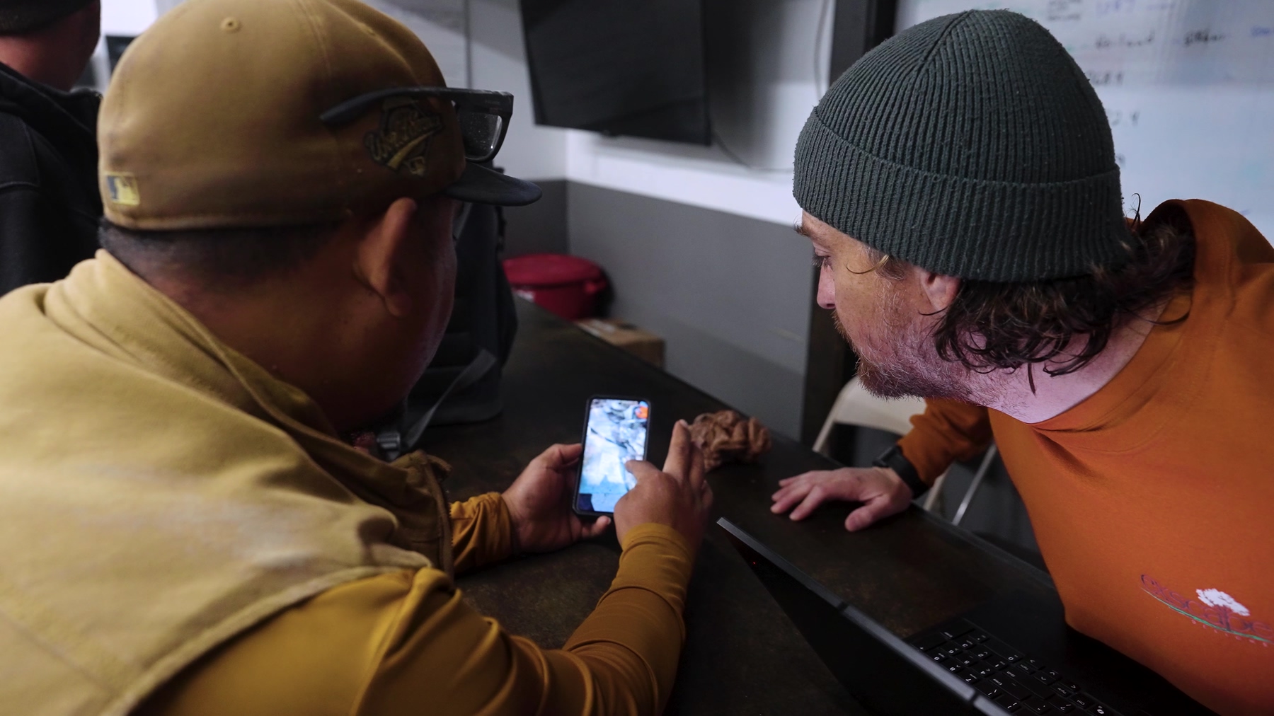 Exscape Group crew members reviewing the days schedule on a phone