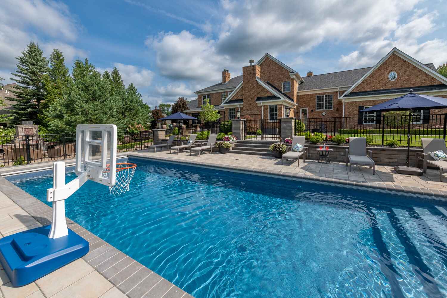 Resort-style pool and spa combination with stone surround