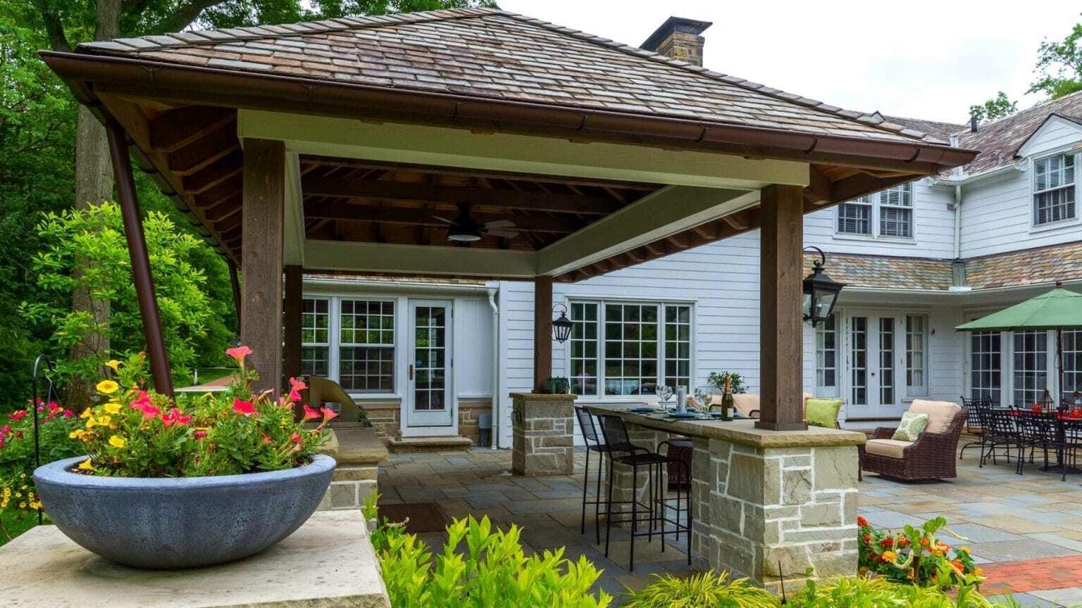 Covered pavilion with seating beside a patio