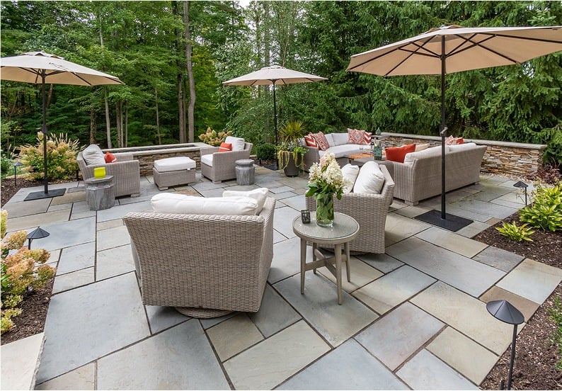 Outdoor living patio design with stone pavers and wicker furniture in Novelty, Ohio by Exscape Group